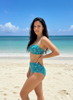 VacationGrabs teal high waist bikini for women's swimwear on a sandy beach with blue ocean backdrop
