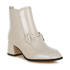 Stylish textured ankle boots for women in beige with a square heel and decorative buckle