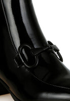 Shiny black textured ankle boots for women with stylish decorative buckle detail