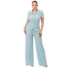 Woman wearing a light blue textured polo set for women with short sleeves and wide-leg pants