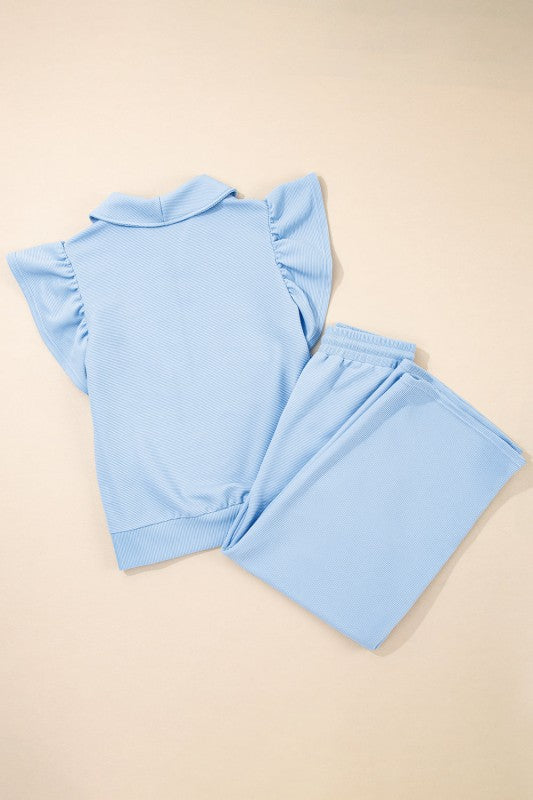 Textured ruffle lounge set in light blue featuring a stylish short-sleeve top and matching pants