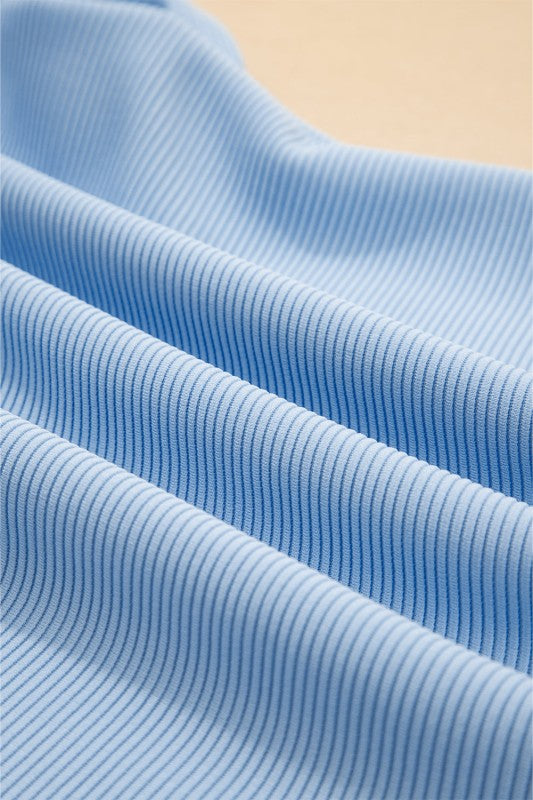 Close-up of soft blue fabric showcasing the texture of the textured ruffle lounge set