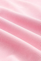 Close-up of pink fabric showcasing texture of the textured ruffle lounge set by JUNIPER BLVD