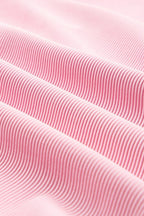 Close-up of pink fabric showcasing texture of the textured ruffle lounge set by JUNIPER BLVD