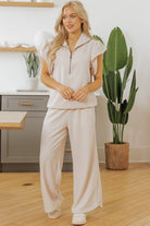 Light pink textured ruffle lounge set featuring a zip-up top and wide-leg pants for comfortable style