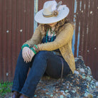 Fashionable woman wearing a leather cuff with natural turquoise and stylish accessories outdoors