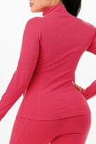 Women's thermal activewear set for women in vibrant pink, featuring a fitted long sleeve top and matching bottoms