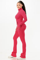 Stylish pink thermal activewear set for women with a fitted top and flared pants