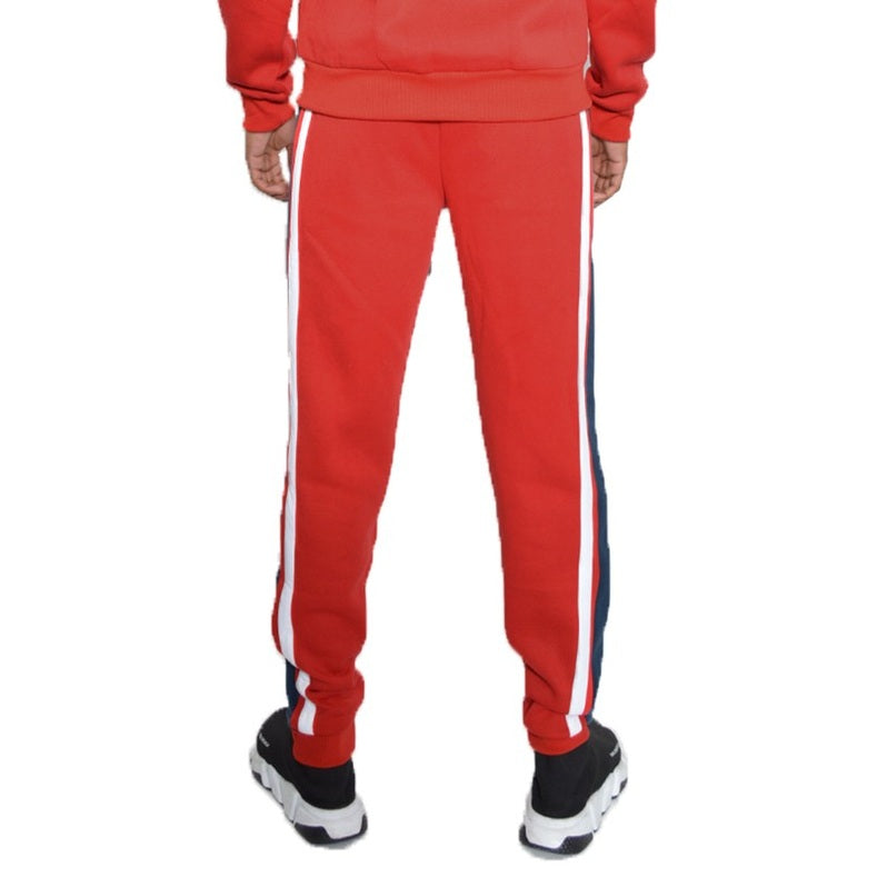 WEIV red three stripe sweatpants for men with white and blue side stripes worn with black and white sneakers