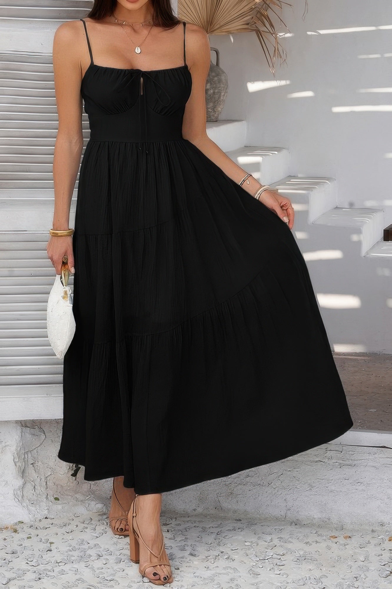 Elegant black tiered cami vacation dress with a flattering silhouette, perfect for warm-weather outings