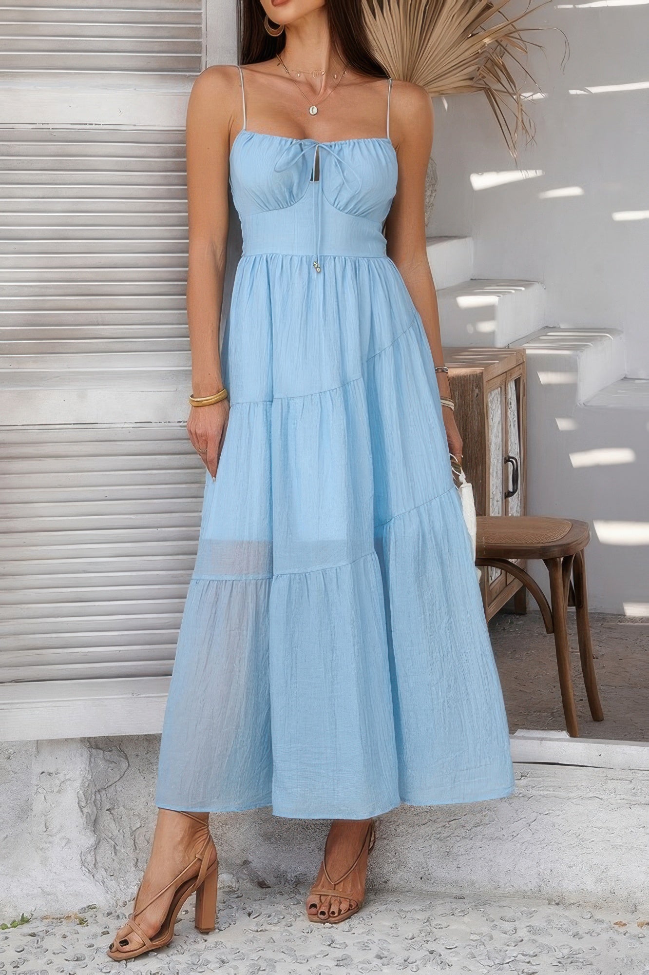 Light blue tiered cami vacation dress with a delicate bodice and flowy skirt, perfect for summer outings