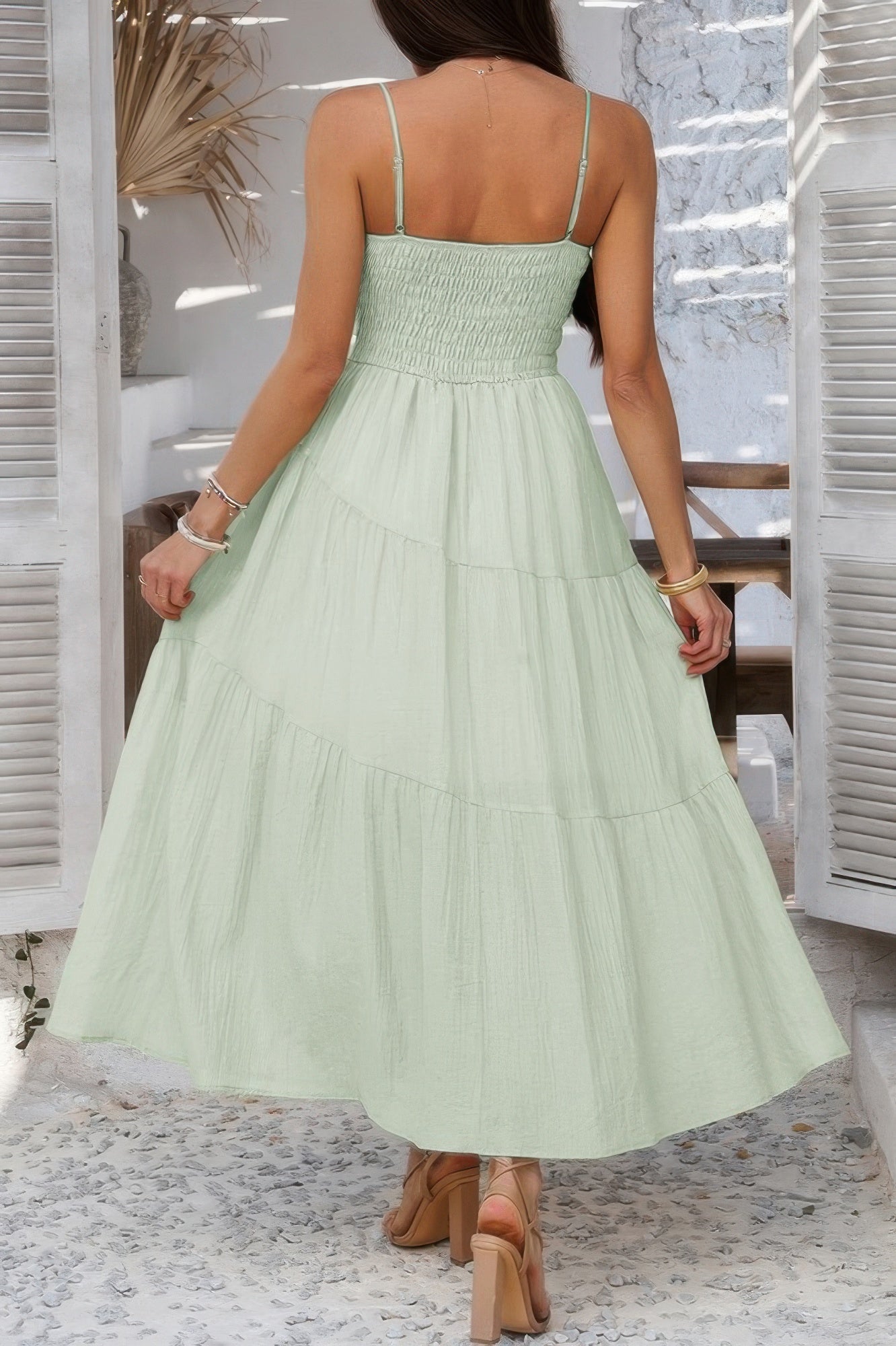 Light green tiered cami vacation dress featuring a smocked bodice and flowy skirt for summer outings