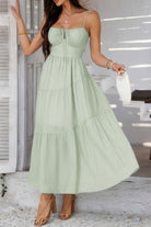 Light green tiered cami vacation dress with a flowy silhouette perfect for summer outings