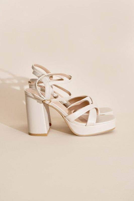 Stylish white cross ankle strap heels with chunky high heel and platform for elegance and comfort