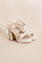 Stylish Top Guy Footwear cross ankle strap heels in white with a chunky block heel