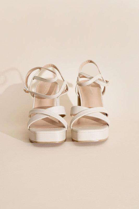 Stylish white cross ankle strap heels with a platform design for women's footwear collection
