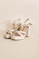 Elegant white cross ankle strap heels with chunky block heels for stylish women
