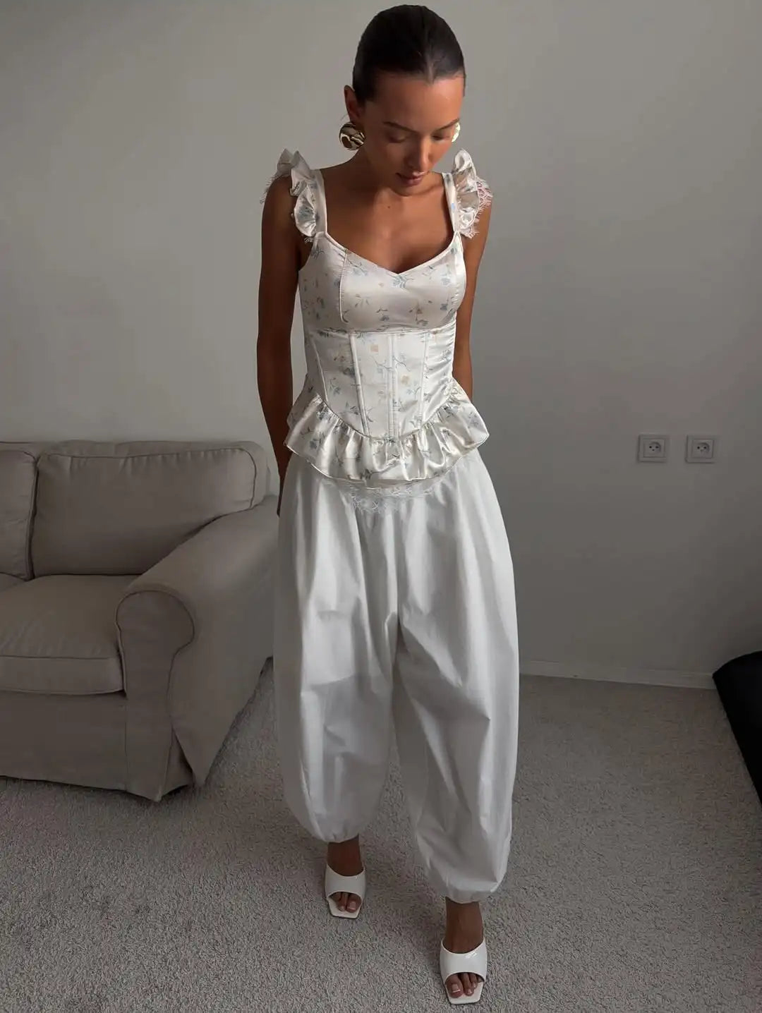 Women's white top with corset, ruffled sleeves and peplum design for casual outings