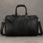 Black leather travel bag with adjustable shoulder strap for easy carrying