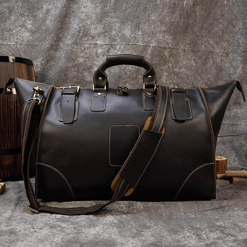 Brown leather travel shoulder bag with sturdy handles and removable shoulder strap for convenience
