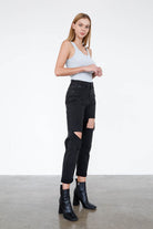 Insane Gene trendy black ripped jeans with a high waist and distressed details, styled with an elegant top