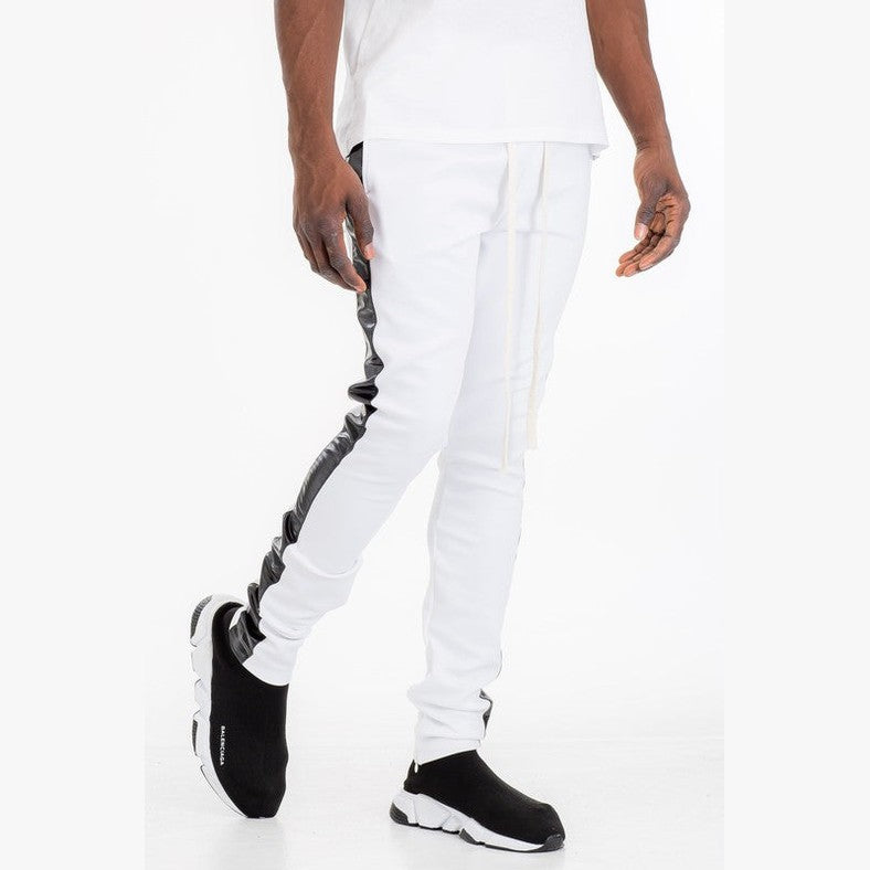 WEIV trendy leather stripe joggers in white with black leather side stripes worn with black slip-on sneakers