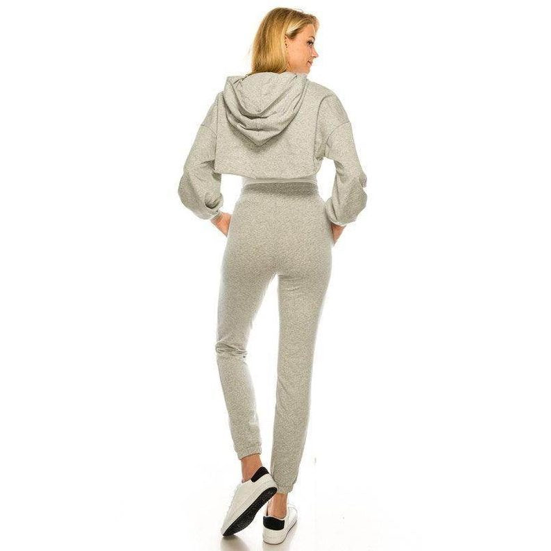Stylish women's trendy two-piece outfit in grey with cropped hoodie and fitted pants
