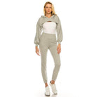 Trendy two-piece outfit featuring a cropped hoodie and fitted pants in light gray for a chic casual look