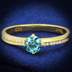 Elegant gold 925 sterling silver ring featuring a round blue stone and sparkling accent stones