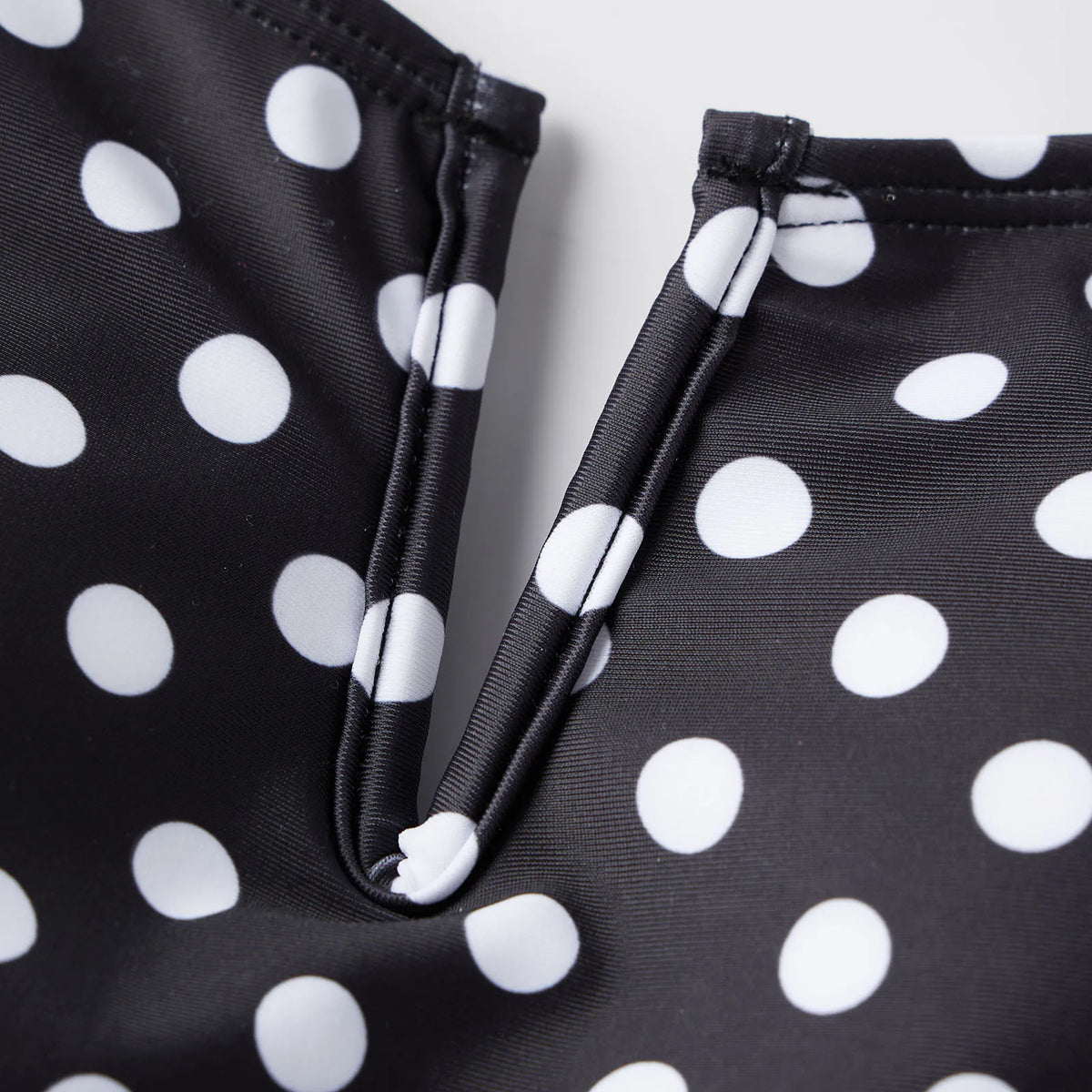 Black tummy control swimsuit with white polka dots for beach outings
