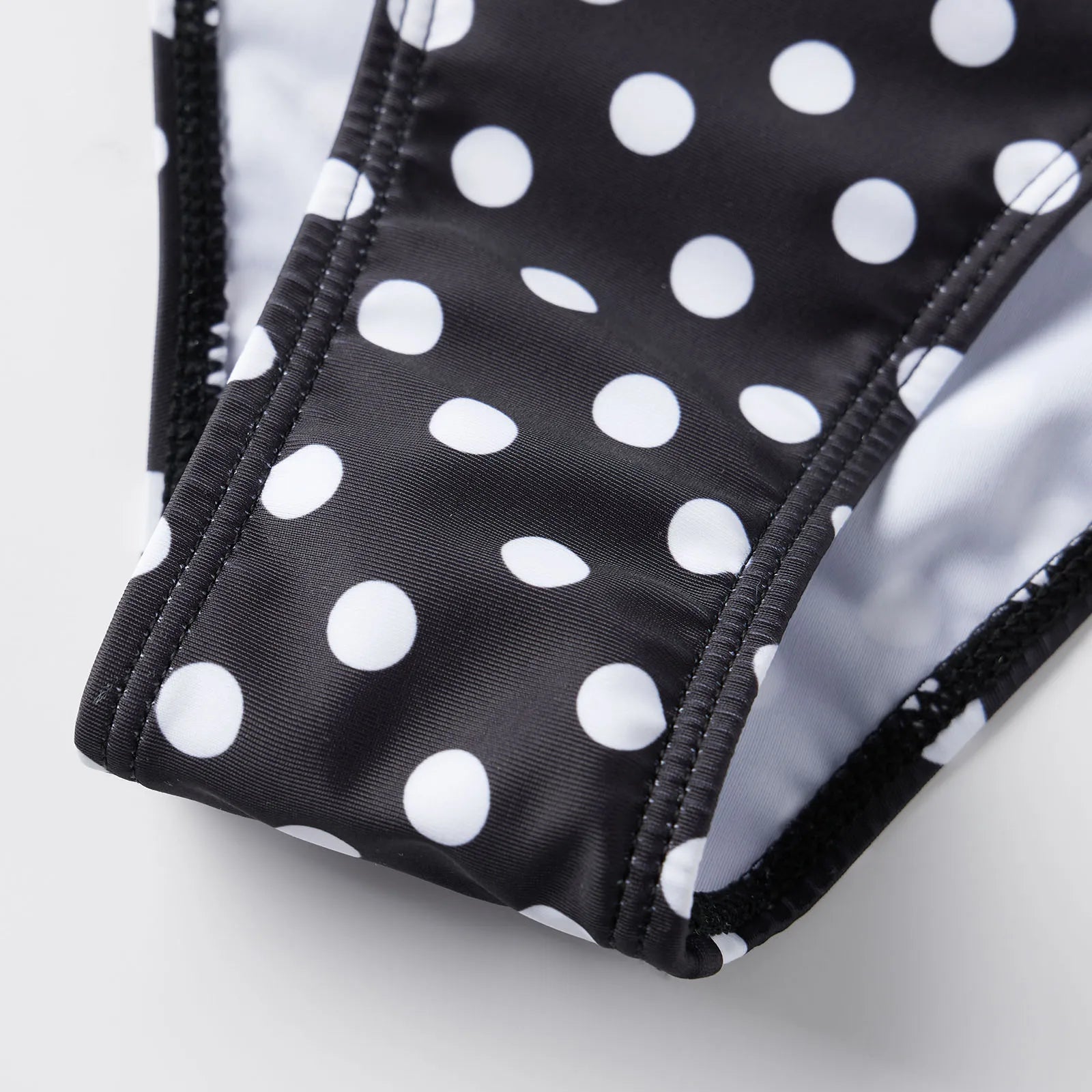 Black and white polka dot tummy control swimsuit for stylish beach outings