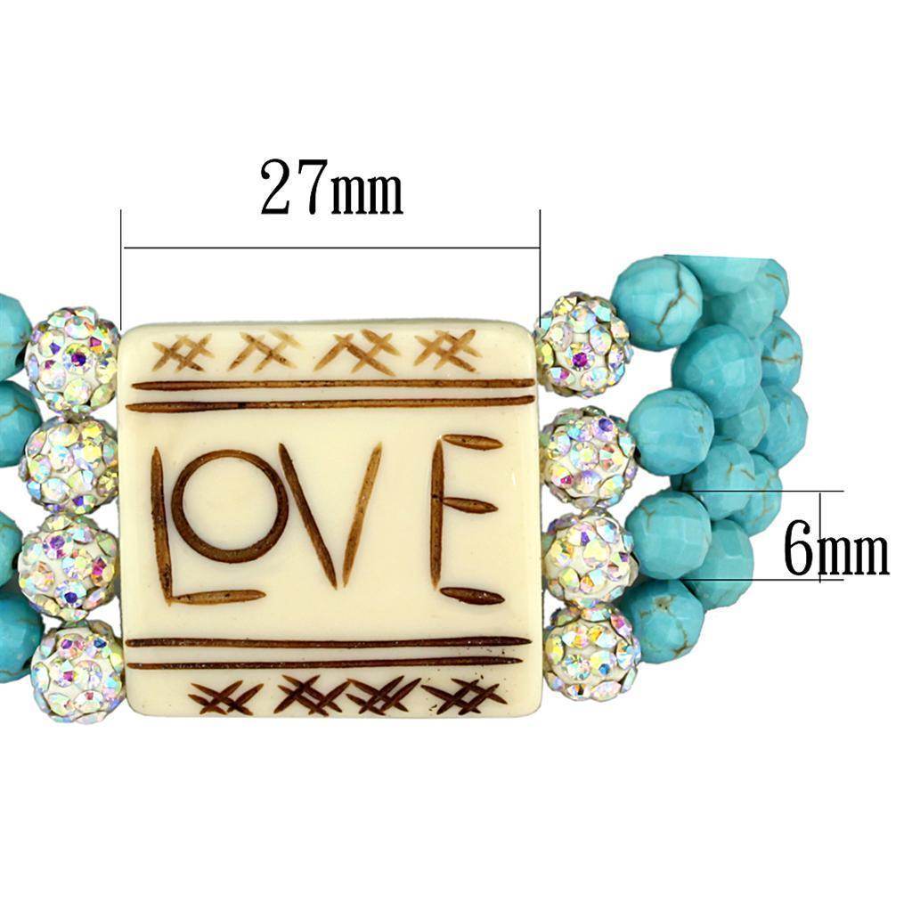 Turquoise beaded brass bracelet featuring a love-themed centerpiece and sparkling accents