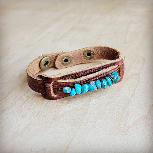 Turquoise stone cuff bracelet on brown leather strap with metal snaps for a stylish look