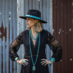 Stylish model wearing a turquoise triple strand bracelet with matching turquoise jewelry