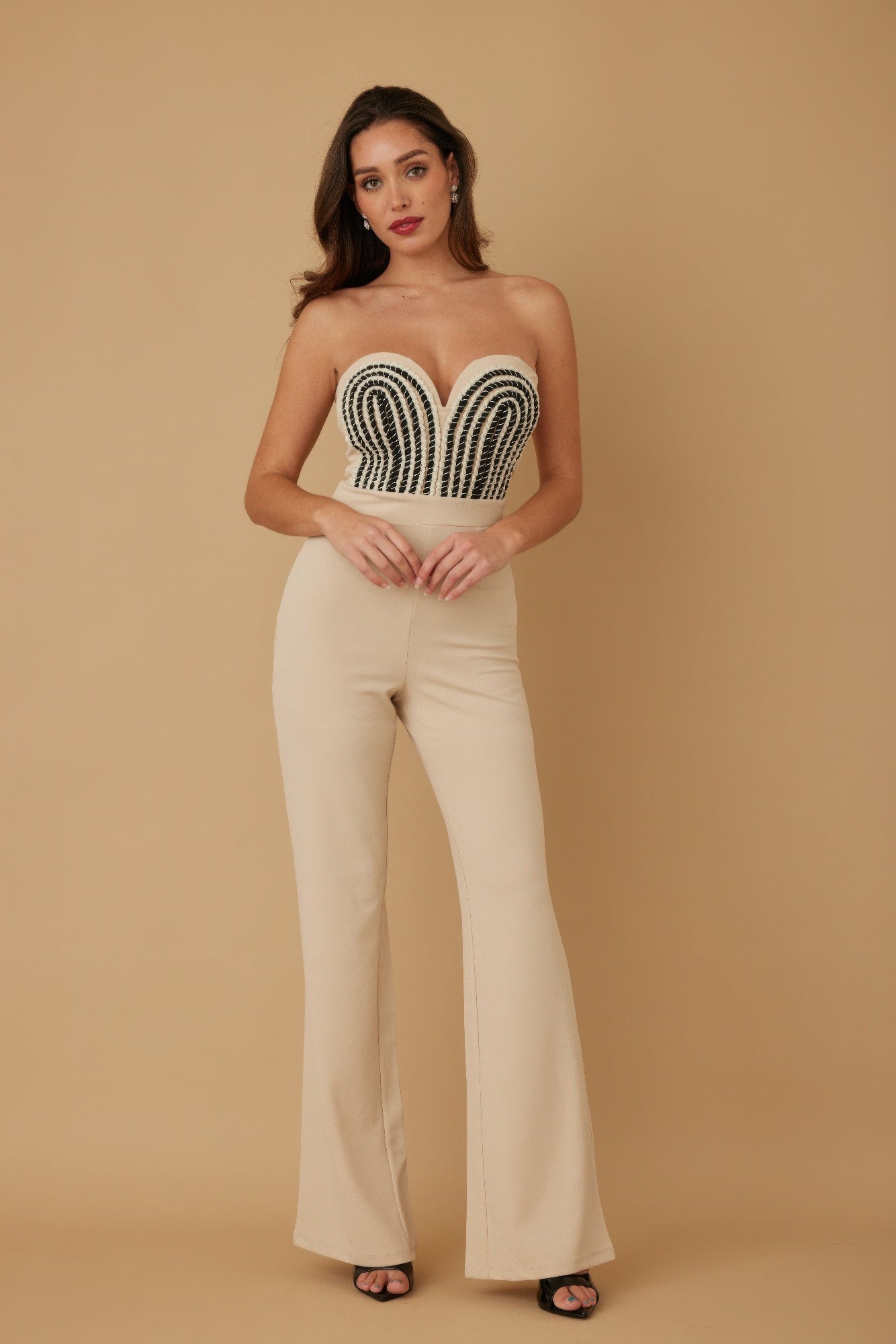 Elegant strapless twisted rope knot jumpsuit in beige with beaded detailing and flared legs