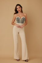 Elegant strapless twisted rope knot jumpsuit in beige with beaded detailing and flared legs