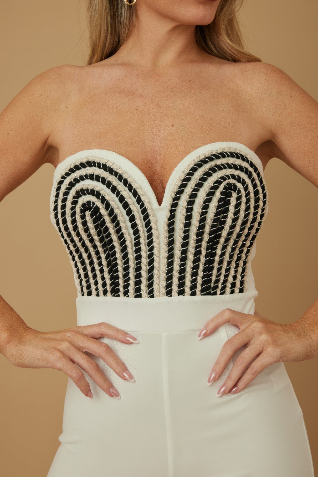 Stylish twisted rope knot jumpsuit featuring a sweetheart neckline and intricate black and white detailing