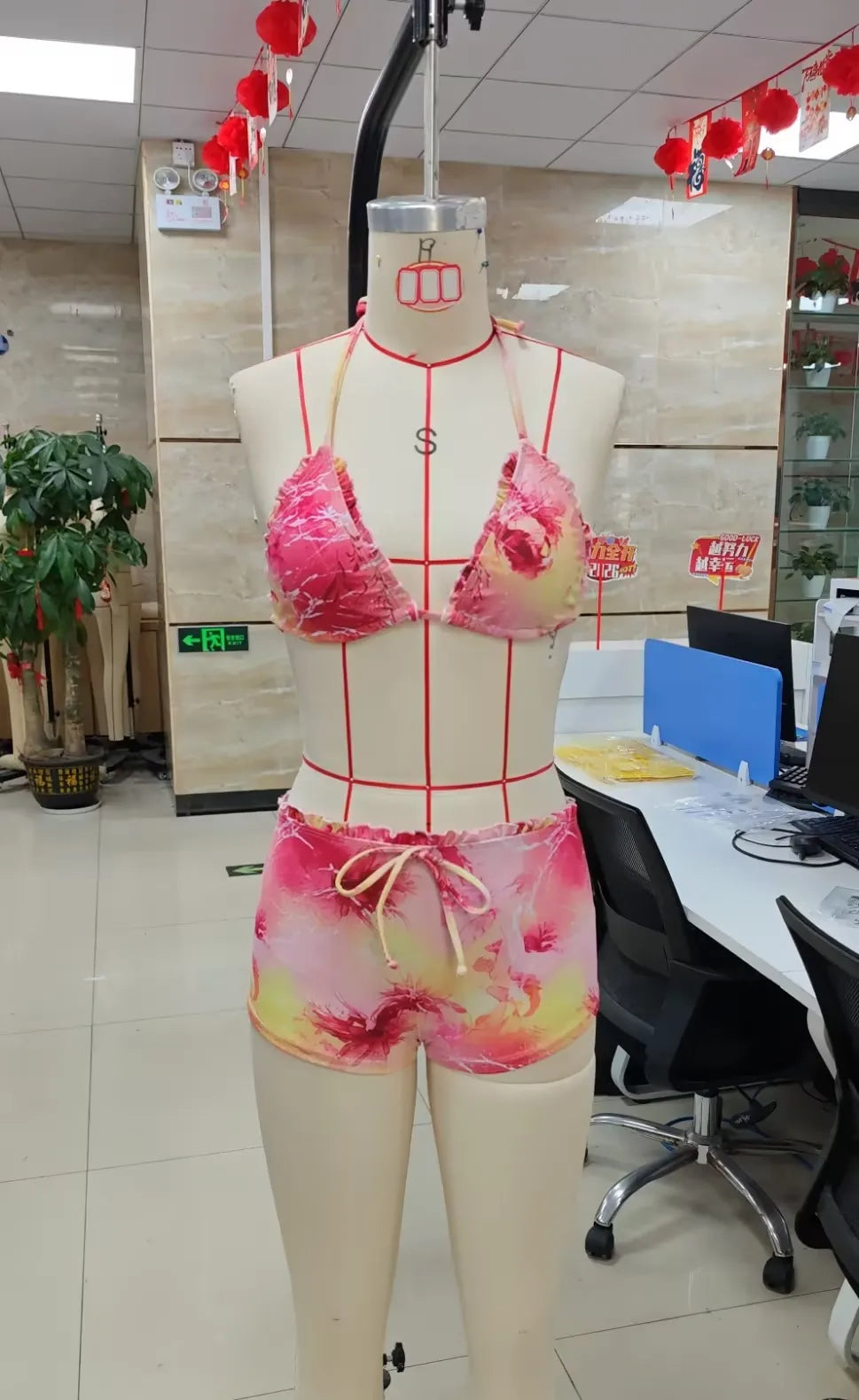 Women's pink and yellow two piece swimsuit, perfect for beachwear