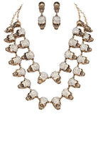 Unique gothic skull jewelry set featuring a necklace and matching earrings with sparkling details