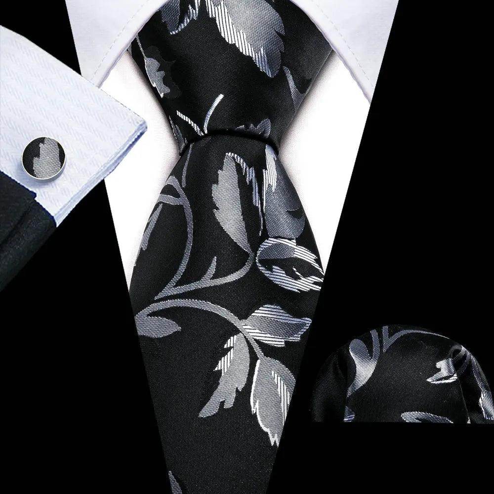 Men's unique necktie designs featuring a black and silver floral pattern, perfect for formal occasions