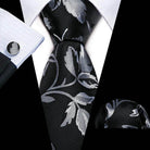Men's unique necktie designs featuring a black and silver floral pattern, perfect for formal occasions