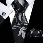 Men's unique necktie designs featuring a black and silver floral pattern, perfect for formal occasions