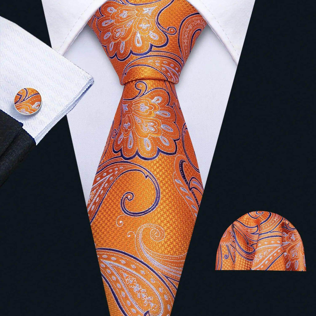 Men's orange tie with unique necktie designs featuring floral patterns, paired with a matching pocket square