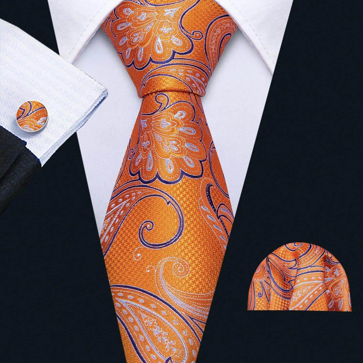 Men's orange tie with unique necktie designs featuring floral patterns, paired with a matching pocket square