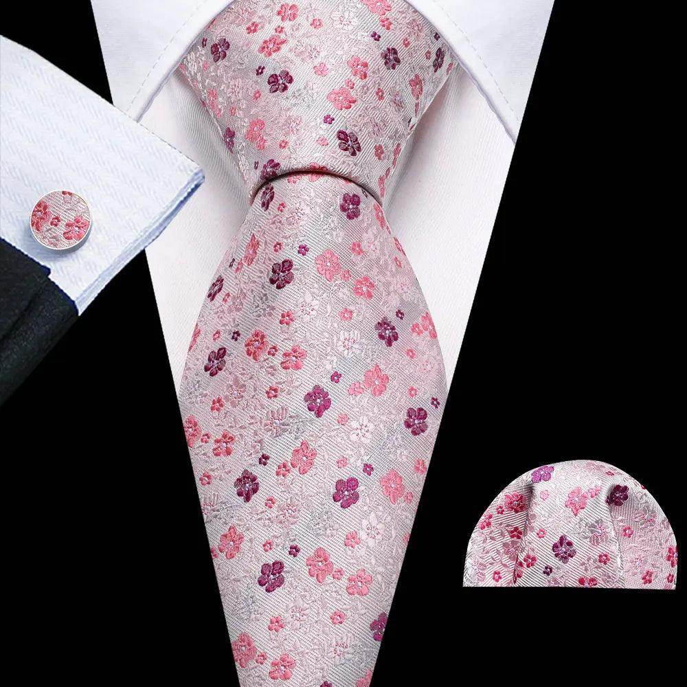 Elegant men's tie with unique necktie designs featuring pink floral patterns on a light background