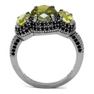 Unique vacation jewelry for women featuring a three-stone ring with green gemstones and intricate detailing