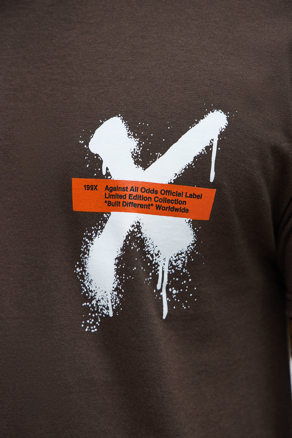 VacationGrabs brown graffiti t shirt men with white paint splatter X design and orange label print