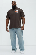 Brown graffiti t shirt men styled with light blue jeans and white sneakers by VacationGrabs