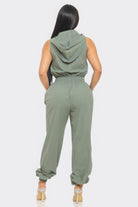 Stylish women's utility jumpsuit for travel in green with a hood and elastic waist for comfort