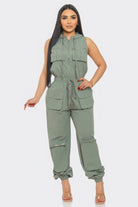 Women's utility jumpsuit for travel in olive green with multiple pockets and adjustable waist